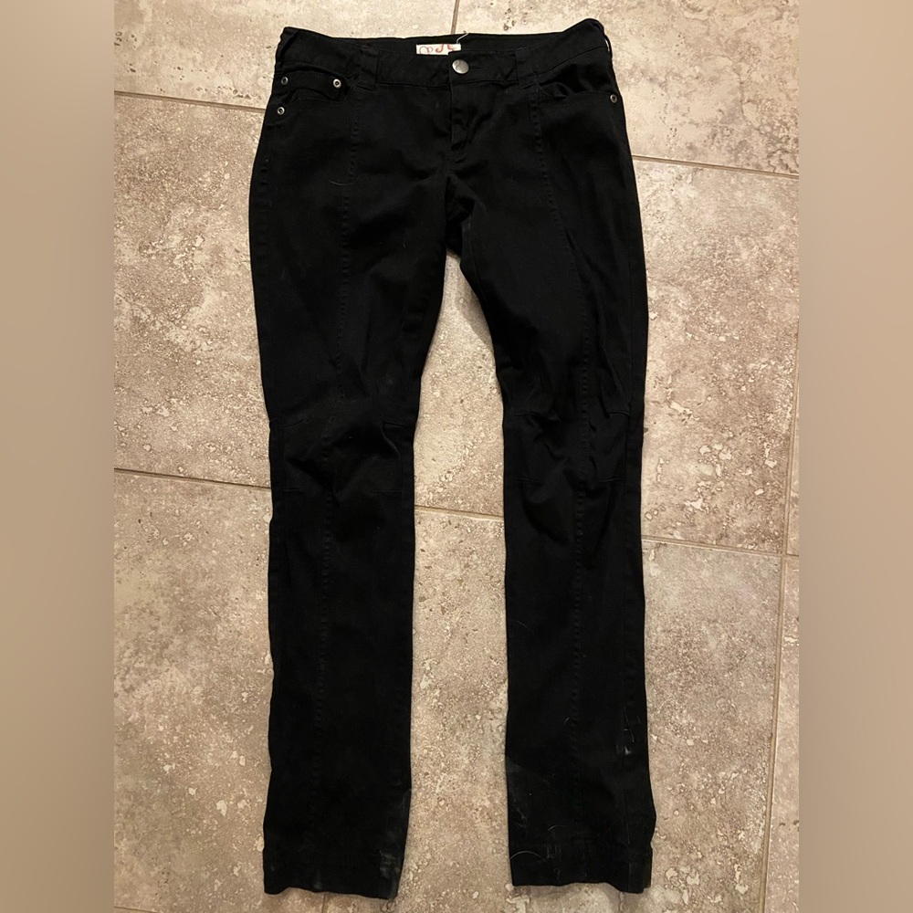Straight leg black pants with buttons on the back pockets. Have never been worn.